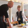 A TCS student presents a project to his father, demonstrating learning through a hands-on, student-led activity.